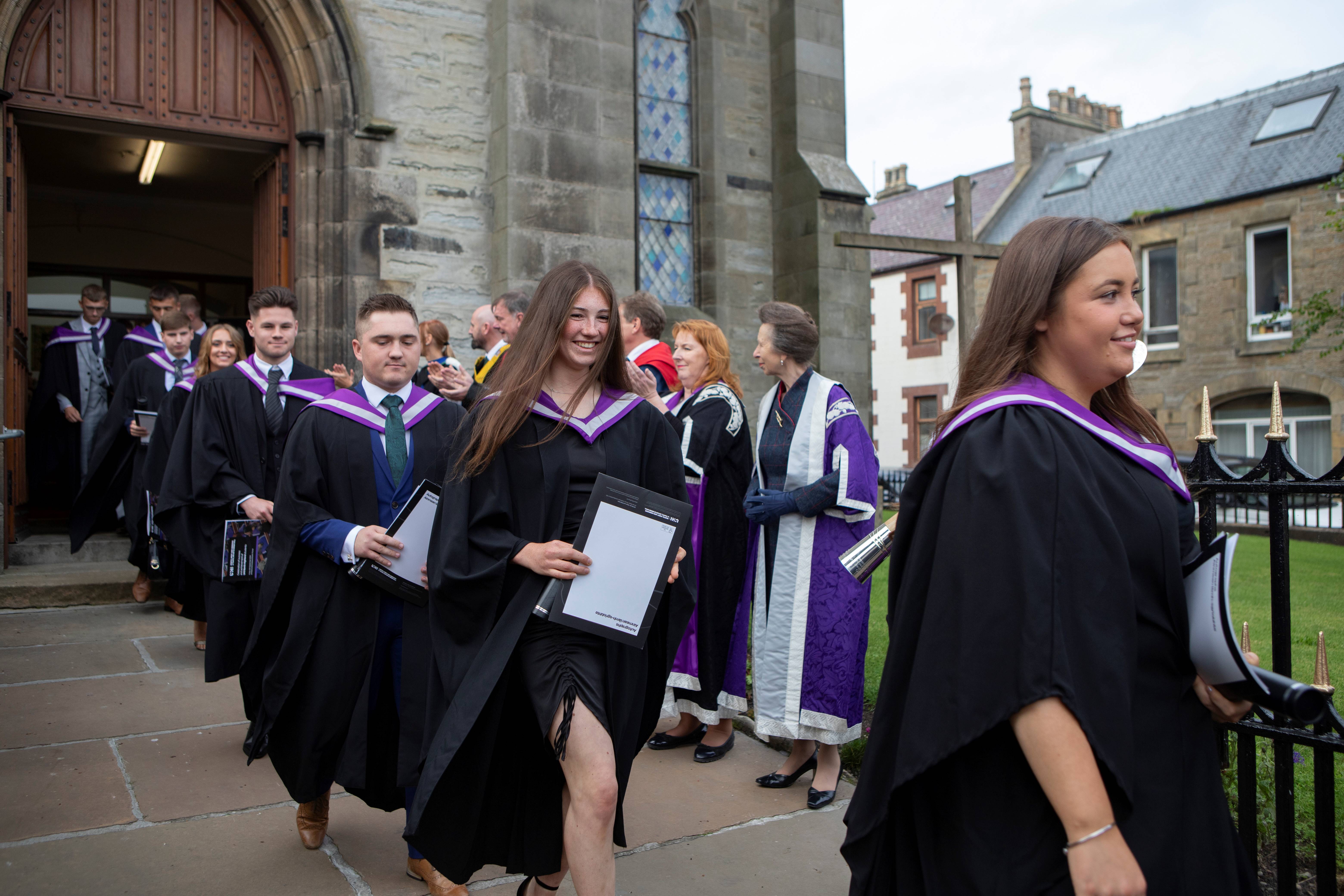 Graduates being clapped out of St Peter's and St Andrew's church by HRH The Princess Royal and the platform party, following the graduation ceremony.
