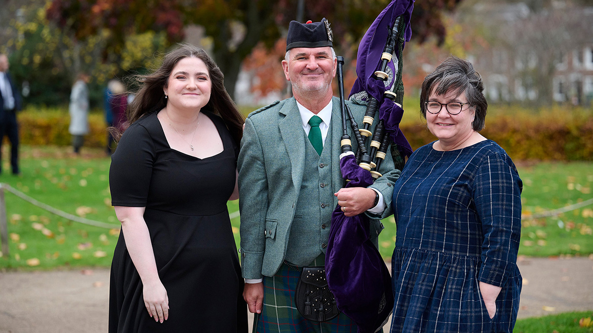Two women standing with a bag piper