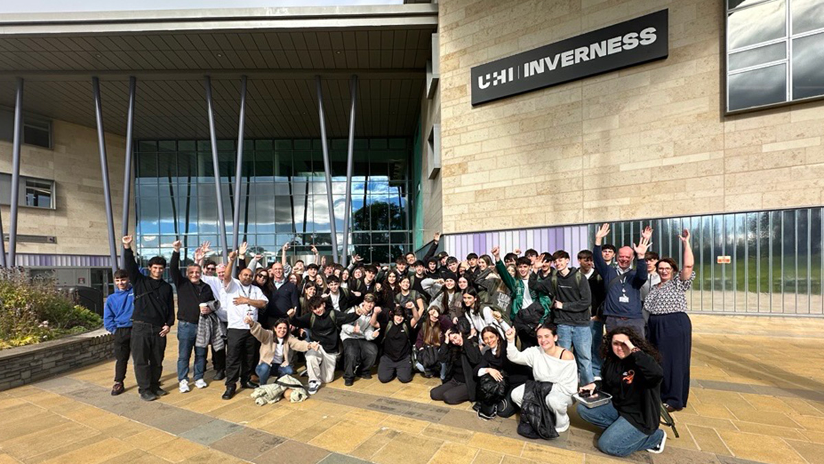 Large group of students and staff outside a college campus Large group of students and staff outside a college campus