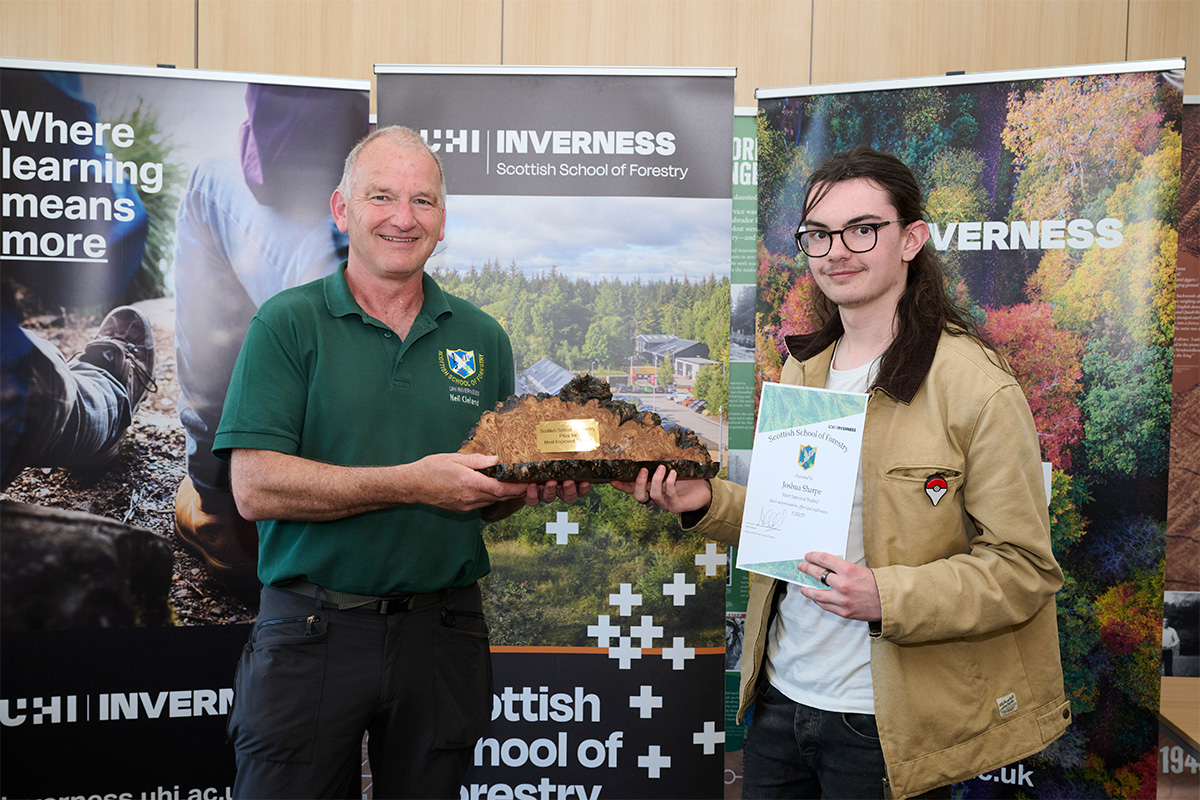 Two men holding an award and certificate Two men holding an award and certificate