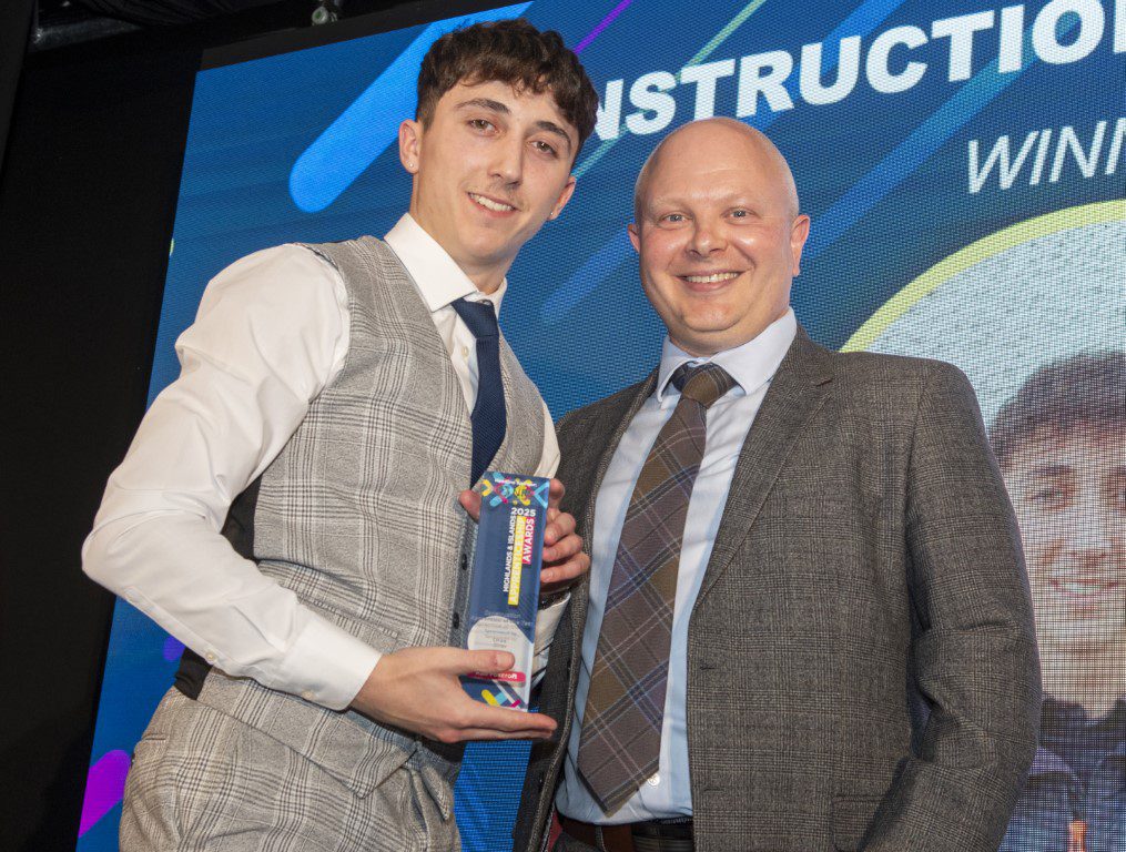 Apprentice Kai receiving an award on stage