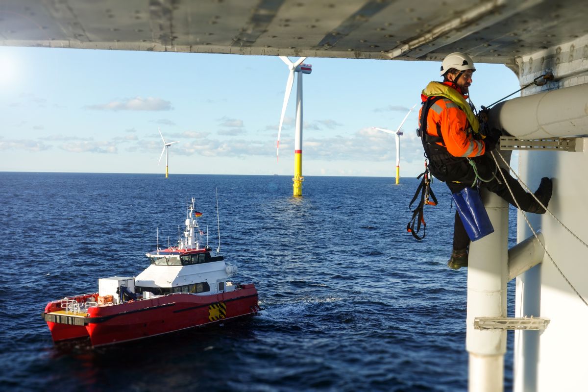 Person doing maintenance on an offshore wind turbine