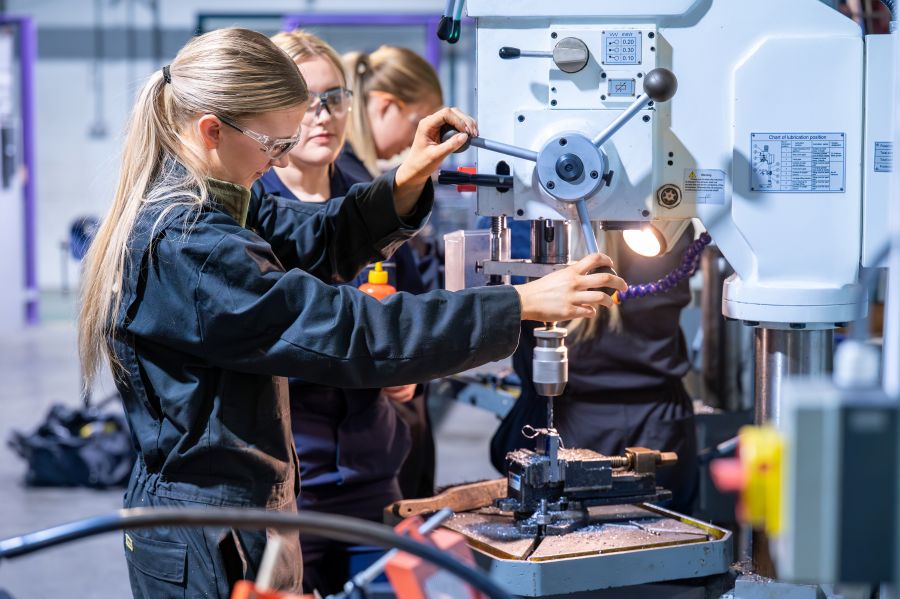 People using manufacturing equipment People using manufacturing equipment