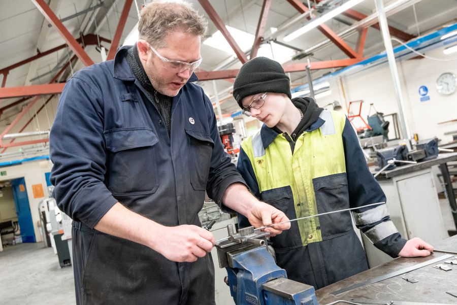 Person demonstrating manufacturing process to another person