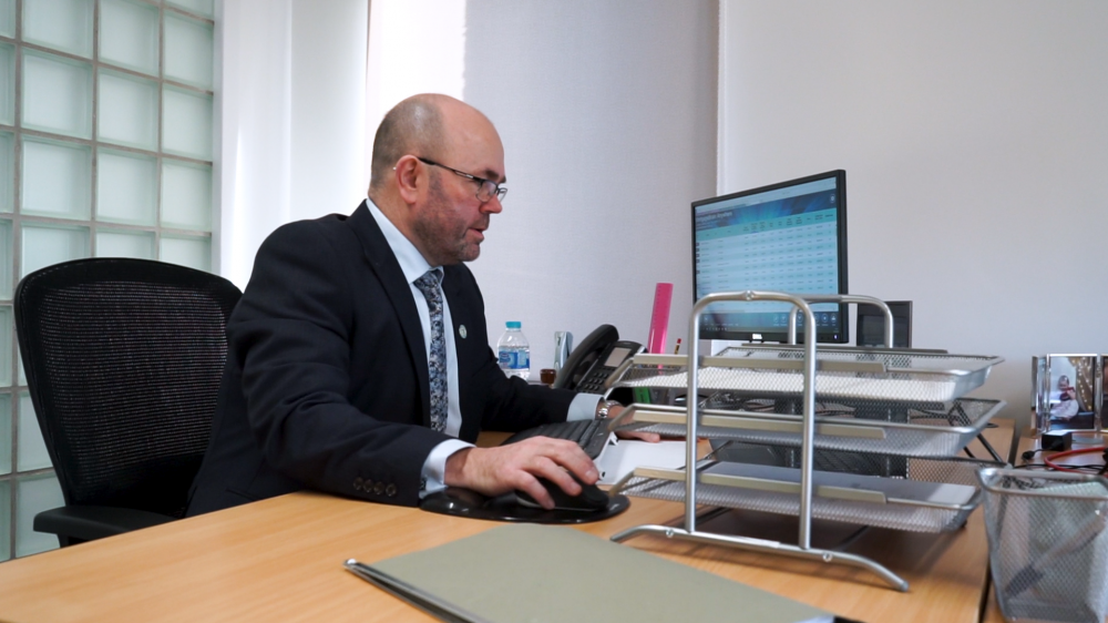 Gregor Howitt sitting at a desk using a computer