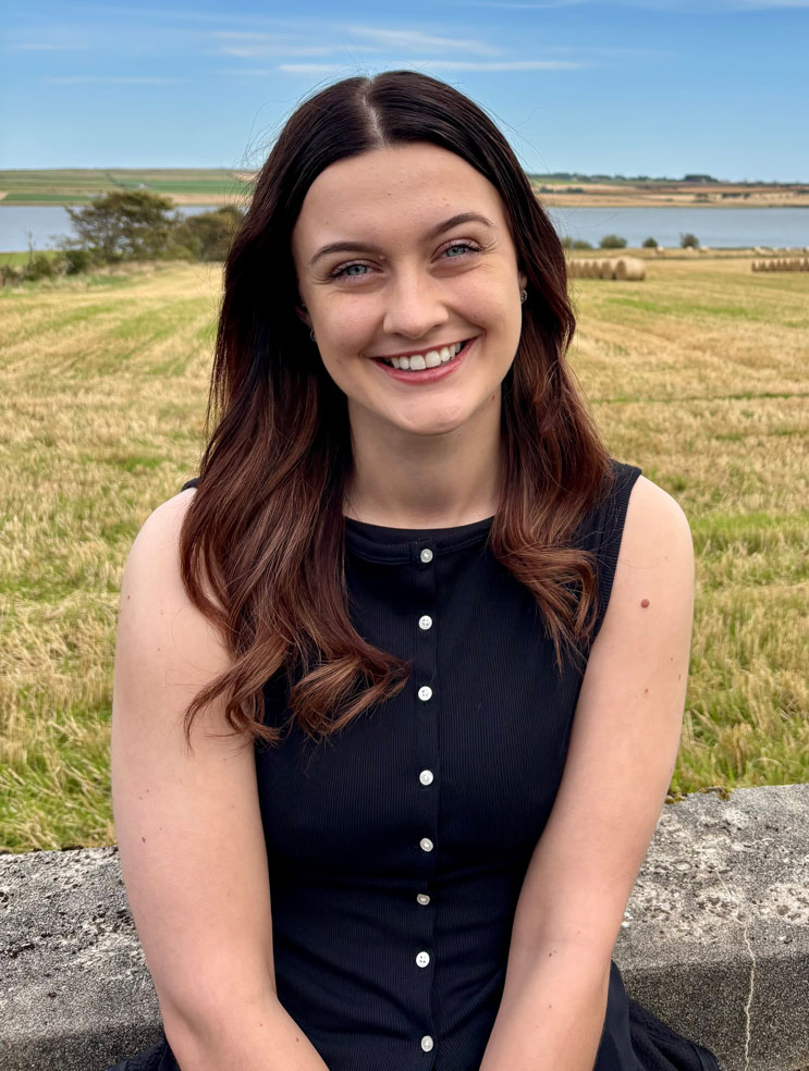 a student sitting and smiling a student sitting and smiling