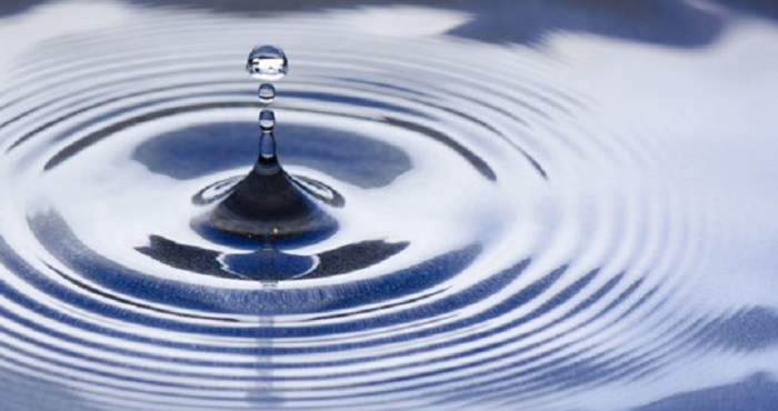 A water droplet falling into water A water droplet falling into water