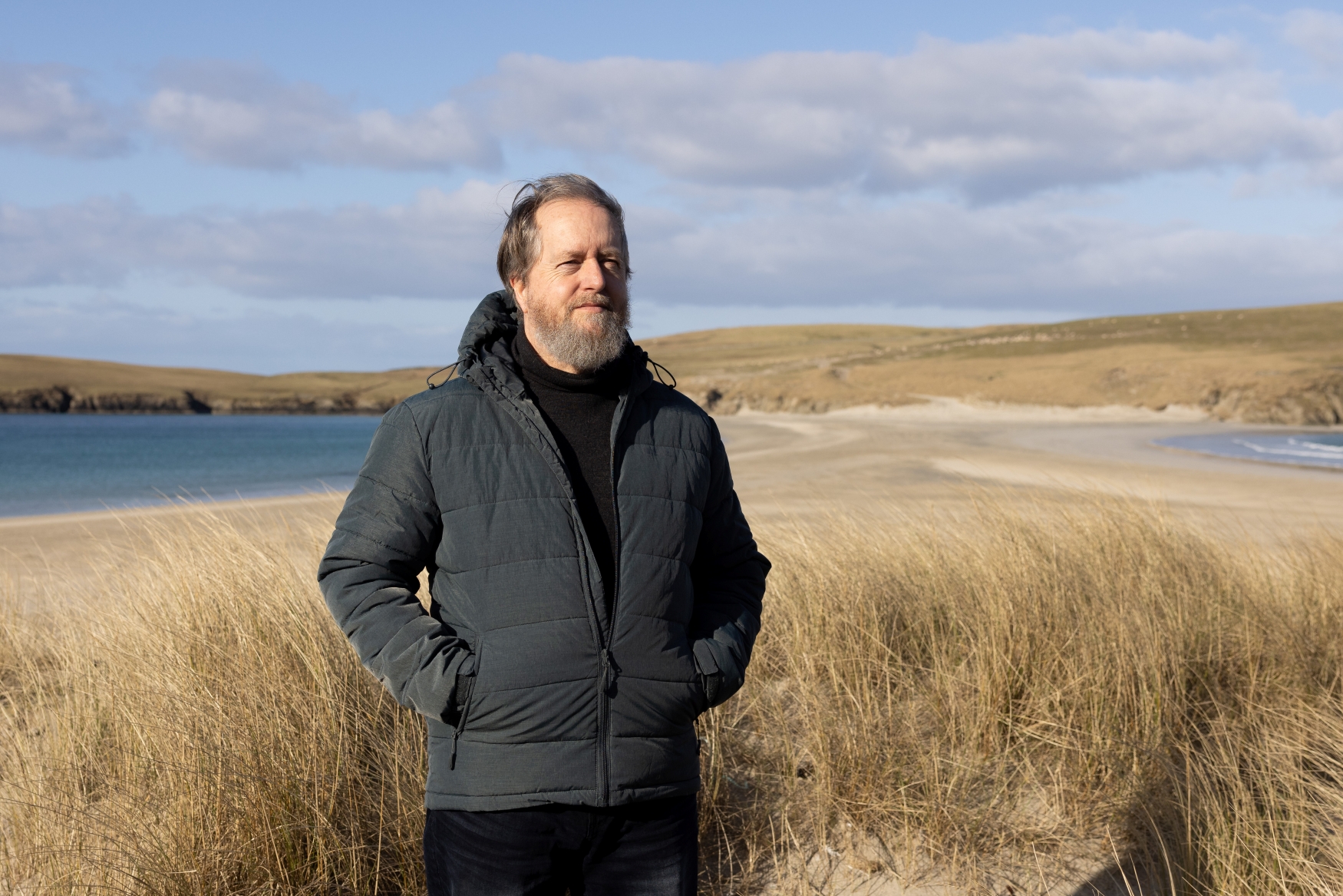 A person standing on a beach on a crisp winter's day