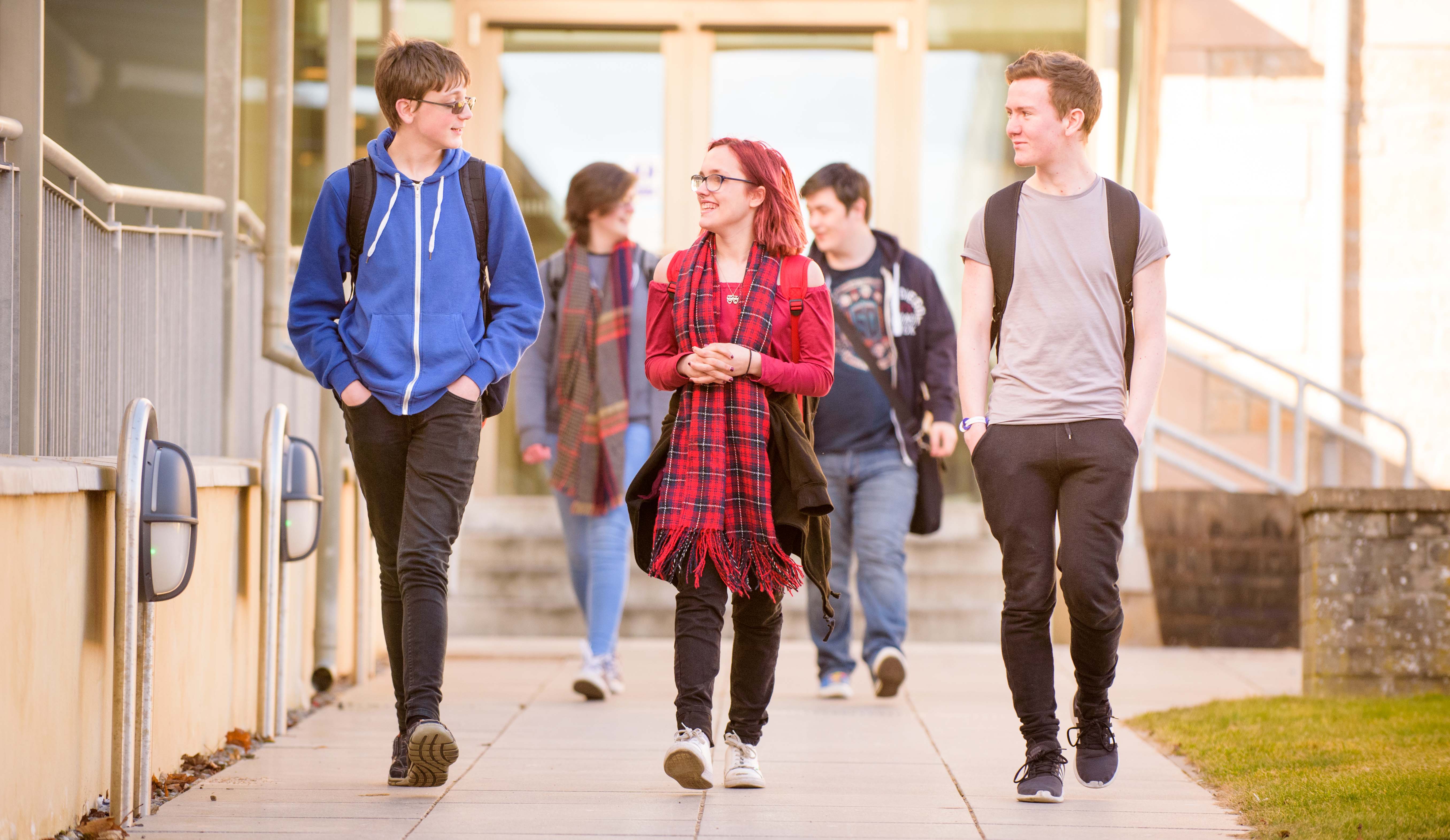 A group of students walking outside a university building