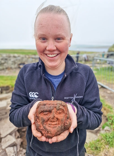 UHI Archaeology Institute student Katie Joss with the Skaill carved head. (Photo: ORCA) UHI Archaeology Institute student Katie Joss with the Skaill carved head. (Photo: ORCA)