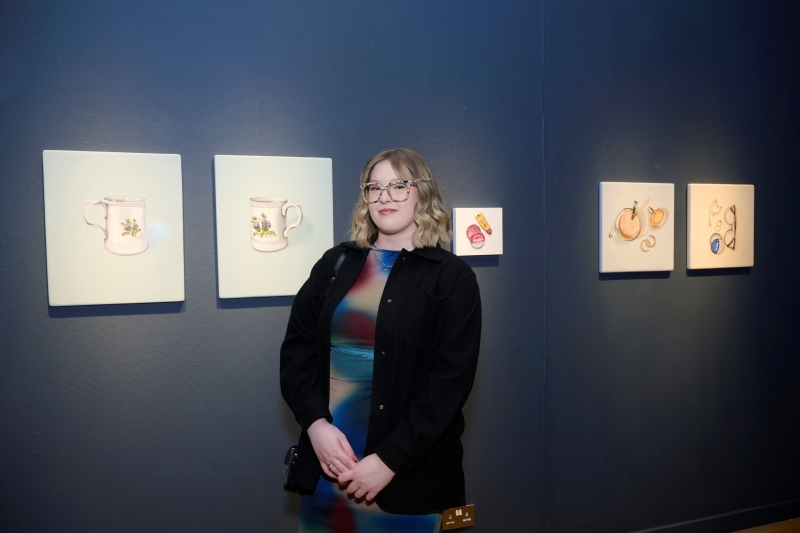 Erin Matheson standing in front of artwork