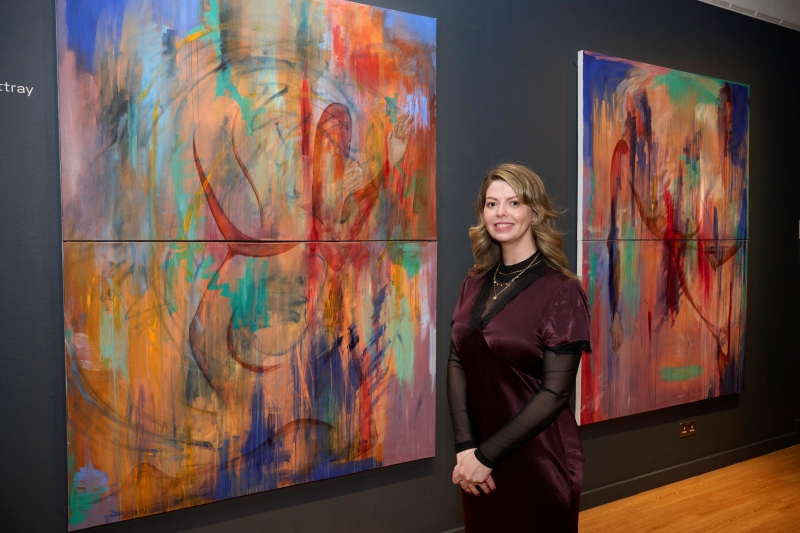 Natalie Rattray standing in front of artwork