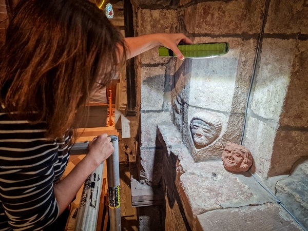 Dr Sarah Jane Gibbon comparing one of the carvings in St Magnus Cathedral to the Skaill head. (Dan Lee) Dr Sarah Jane Gibbon comparing one of the carvings in St Magnus Cathedral to the Skaill head. (Dan Lee)