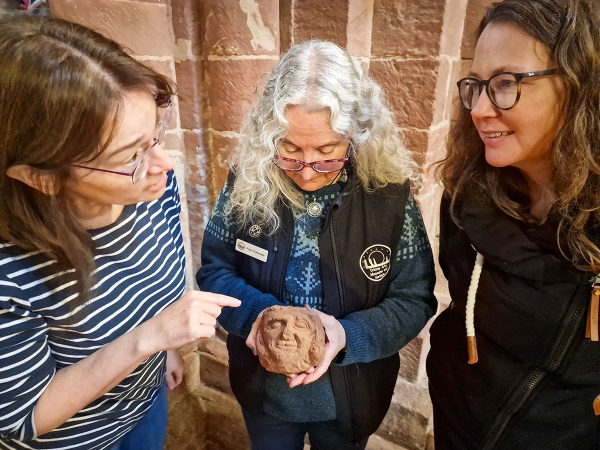 The UHI Archaeology Institute’s Dr Sarah Jane Gibbon (left) and Dr Jen Harland discuss the Skaill head with St Magnus Cathedral curator Fran Flett Hollinrake. (Photo Dan Lee The UHI Archaeology Institute’s Dr Sarah Jane Gibbon (left) and Dr Jen Harland discuss the Skaill head with St Magnus Cathedral curator Fran Flett Hollinrake. (Photo Dan Lee