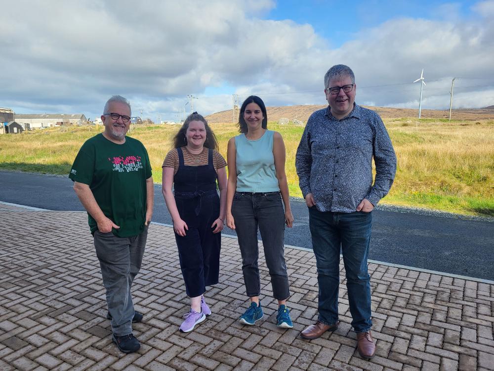 Group of two men and two women smiling at the camera