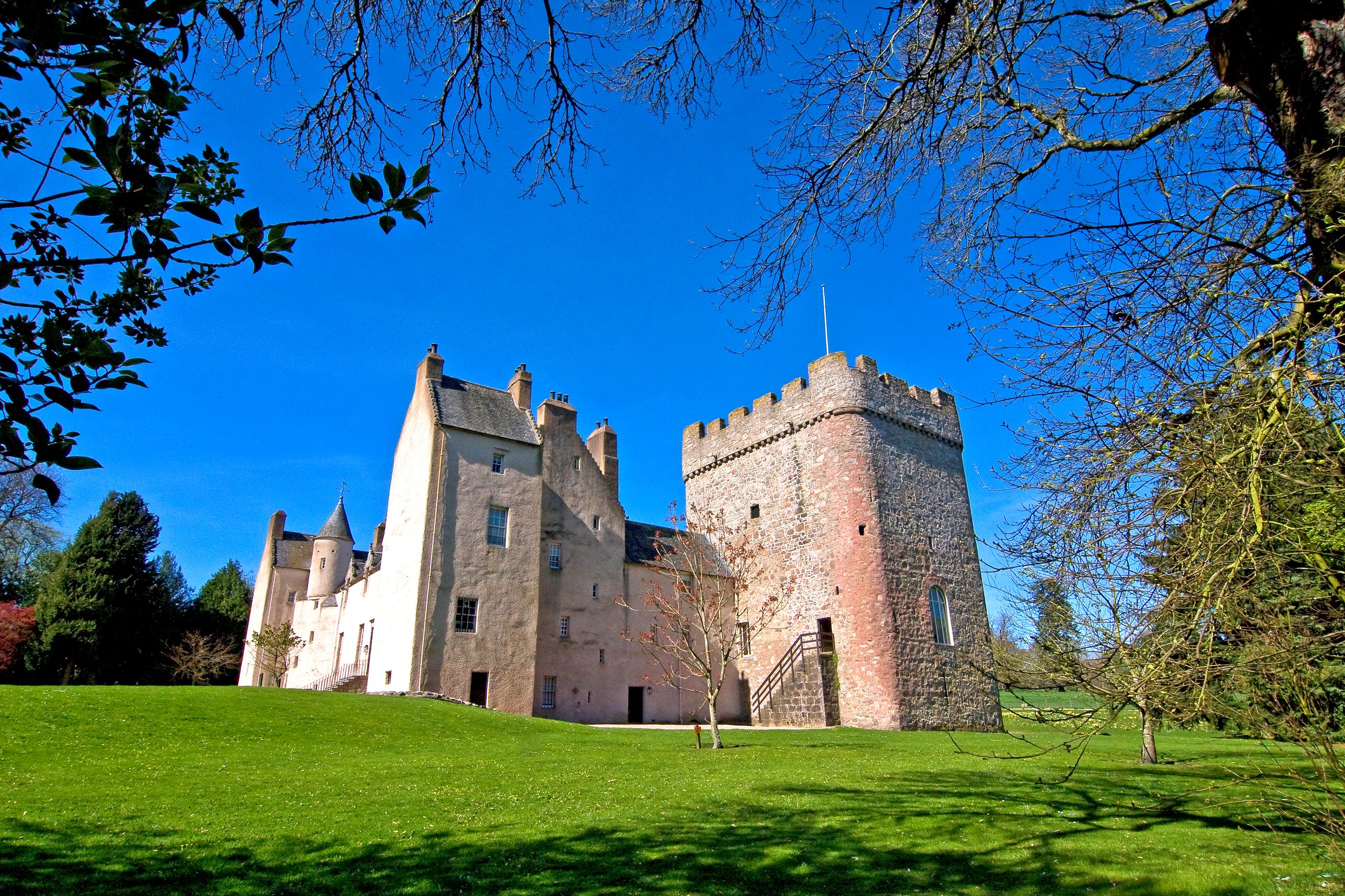 A castle with a grassy slope leading to it