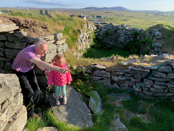 A person and a child looking at historic ruin
