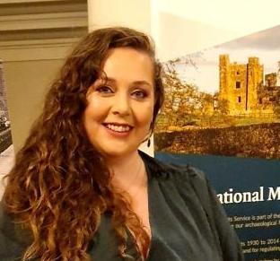 Woman smiling at a camera with a pop-up banner showing a ruined castle behind her. Woman smiling at a camera with a pop-up banner showing a ruined castle behind her.