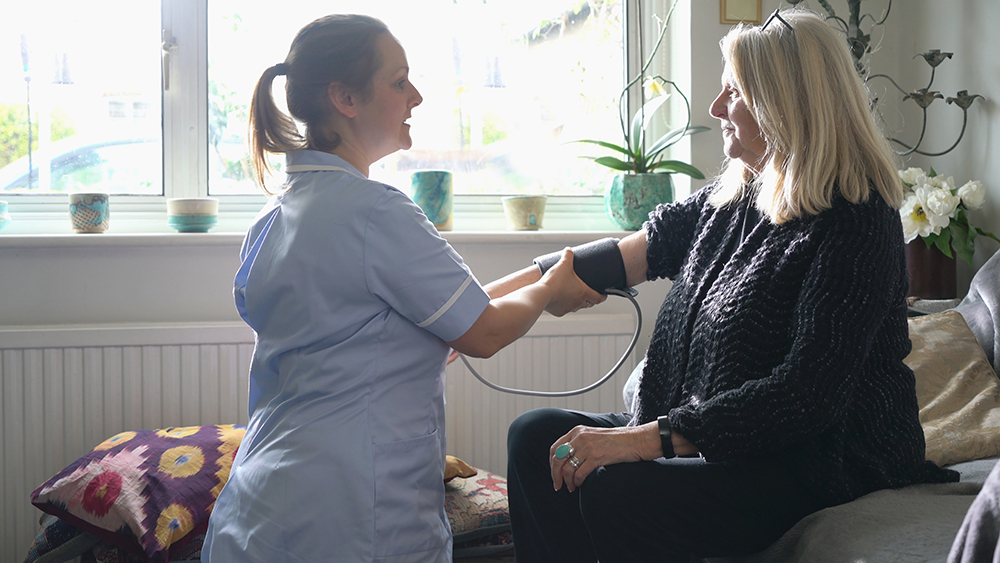 A nurse taking a persons blood pressure A nurse taking a persons blood pressure
