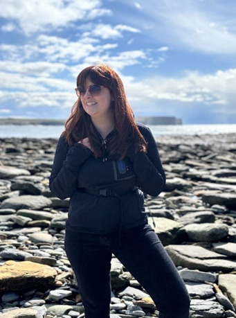 A photograph of Meg Denmark-Melvin on the beach