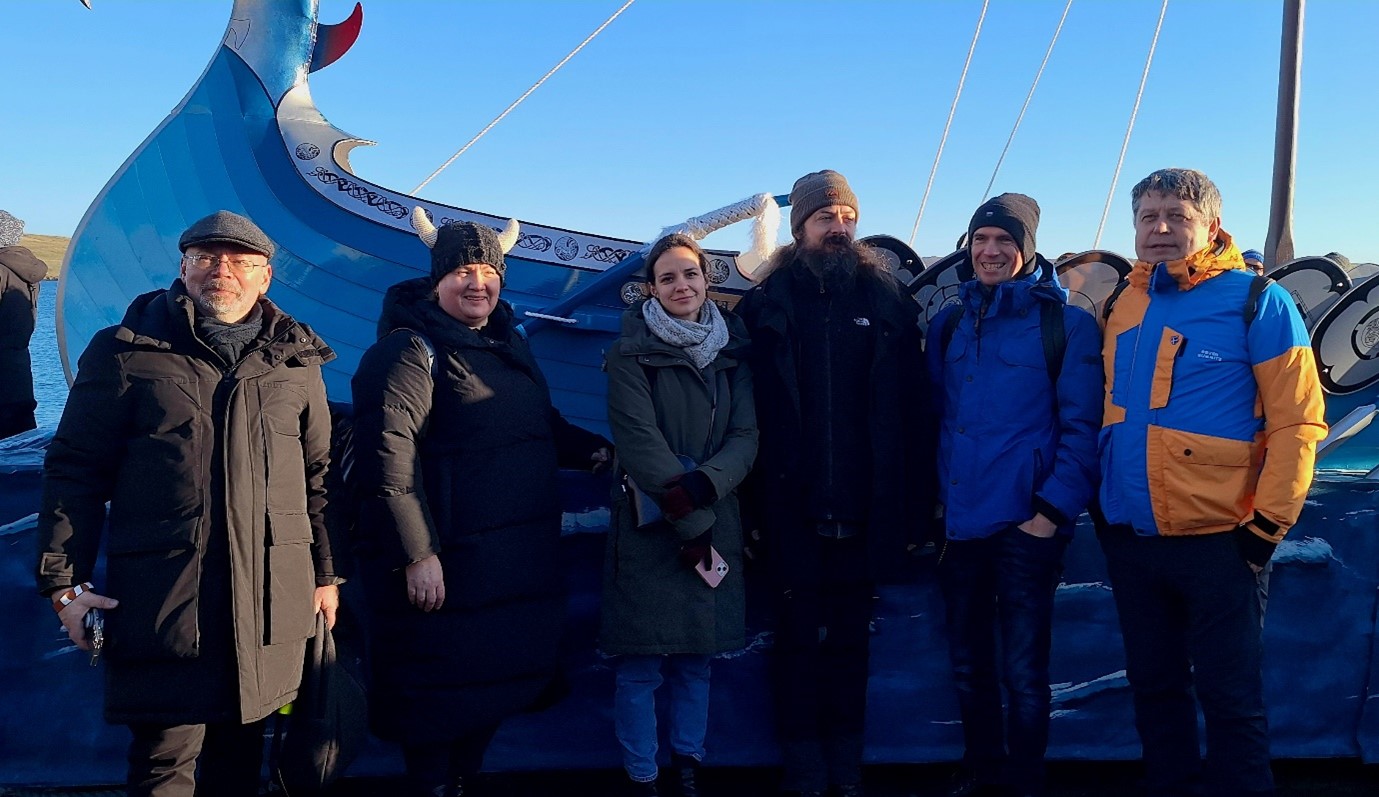 HerInDep team members Kęstutis Zaleckis Aušra Mlinkauskienė Ingrida Povilaitienė Marek Jakoubek Marius Ivaškevičius and Ivan Murin pose in front of the 2024 Lerwick UpHellyAa longship Photo Credit Dr A Lind HerInDep team members Kęstutis Zaleckis Aušra Mlinkauskienė Ingrida Povilaitienė Marek Jakoubek Marius Ivaškevičius and Ivan Murin pose in front of the 2024 Lerwick UpHellyAa longship Photo Credit Dr A Lind