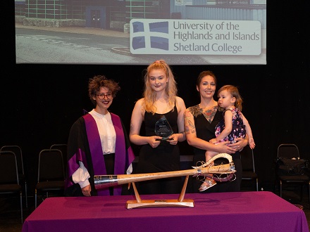 Natasha Morgan, HISA VPFE, presenting some of the members of the Shetland Students' Green Team with their award.