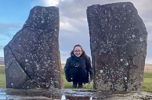 Mila crouching at the Stones of Stenness, Orkney Mila crouching at the Stones of Stenness, Orkney