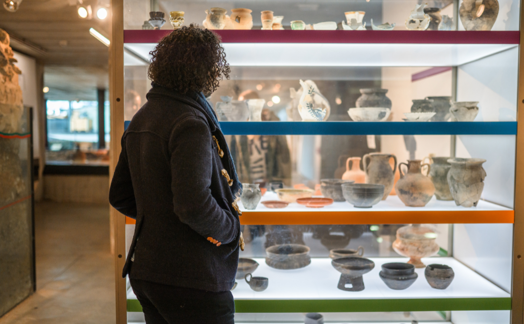 Woman walking around a pottery exhibition Woman walking around a pottery exhibition