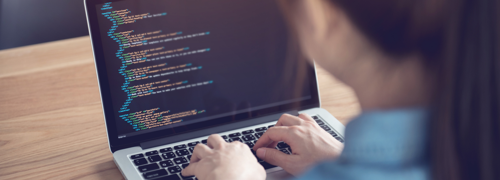 Person coding at laptop Person coding at laptop